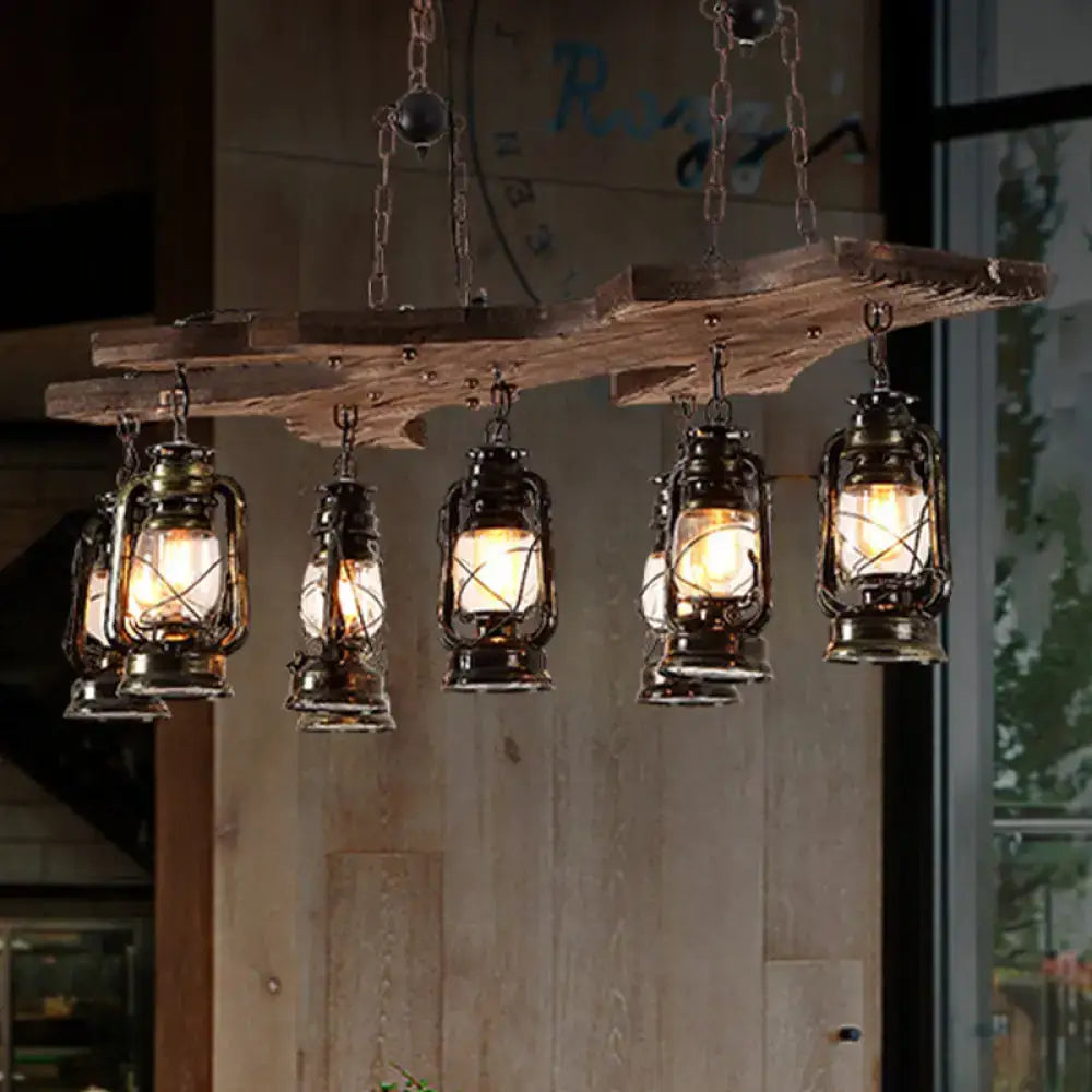 Decorbites vintage industrial linear chandelier with five antique brass lanterns hanging from rustic wooden beams