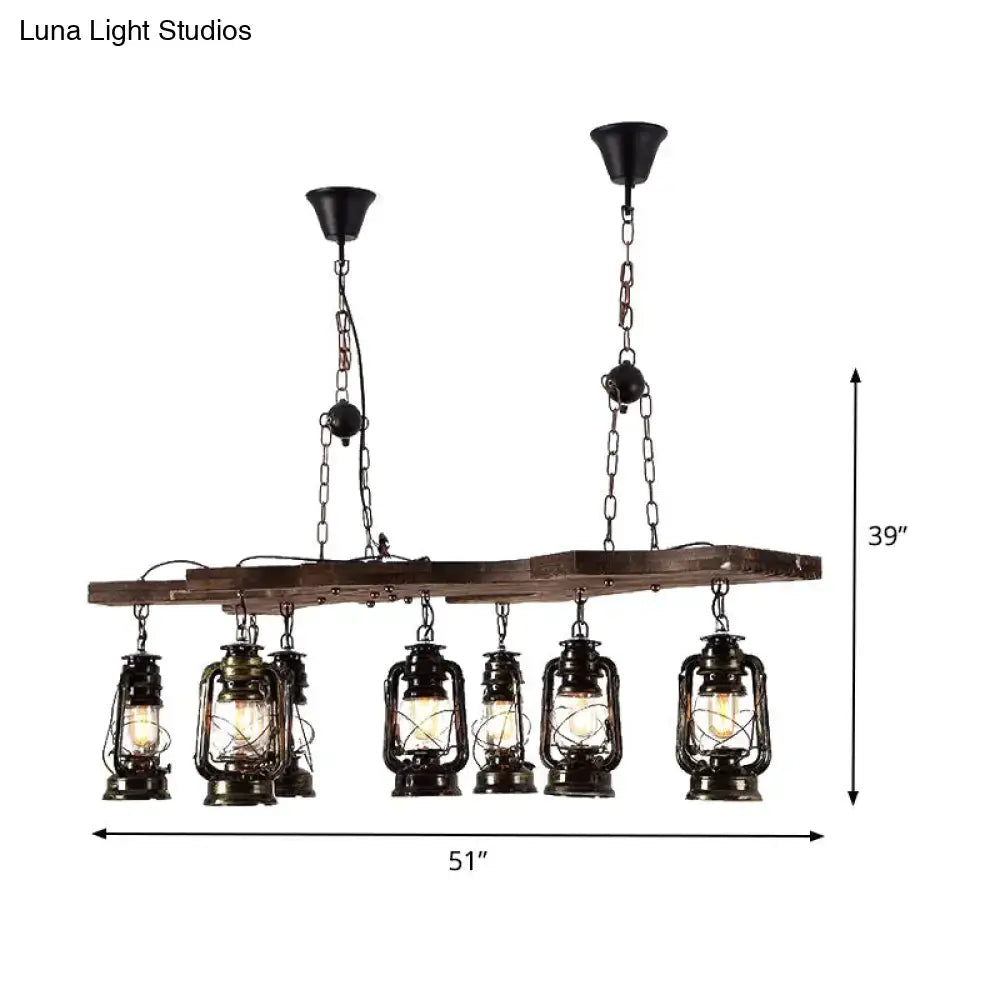 DecorBites™ vintage industrial linear chandelier with six black lanterns and antique brass accents on a rustic beam