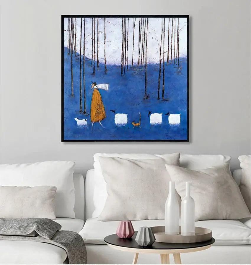 Blue-framed DecorBites™ vintage nordic abstract canvas art showing a figure in orange robe walking with sheep in forest