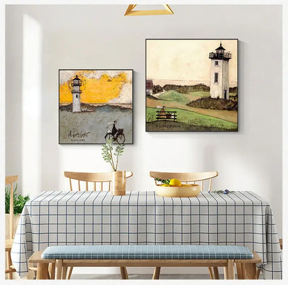 Two framed lighthouse paintings in vintage nordic abstract landscape style hang above a dining table wall decor