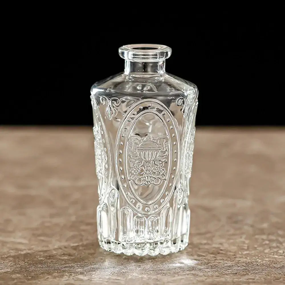 Clear glass vintage relief vase with intricate embossed floral and scrollwork design for hydroponic plants