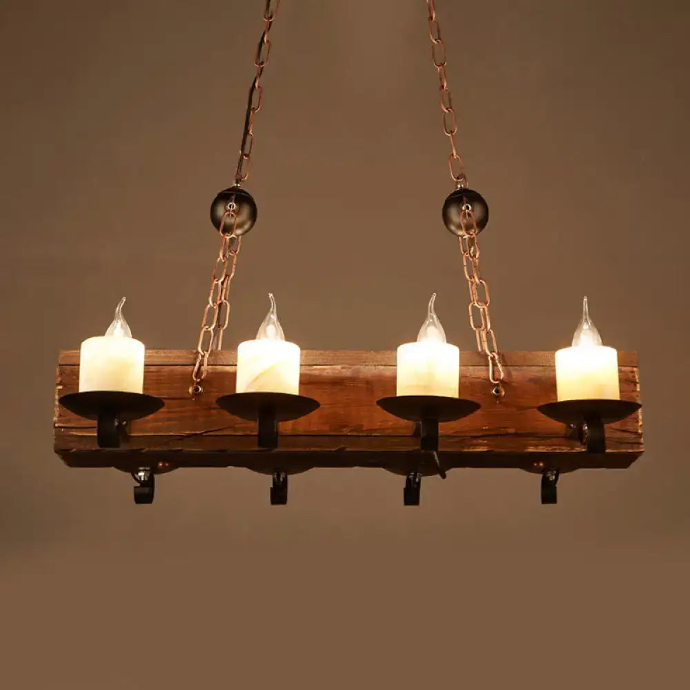 Rustic wooden chandelier with four glowing white candle-style led bulbs in black metal holders and copper chains for 110v-120v use