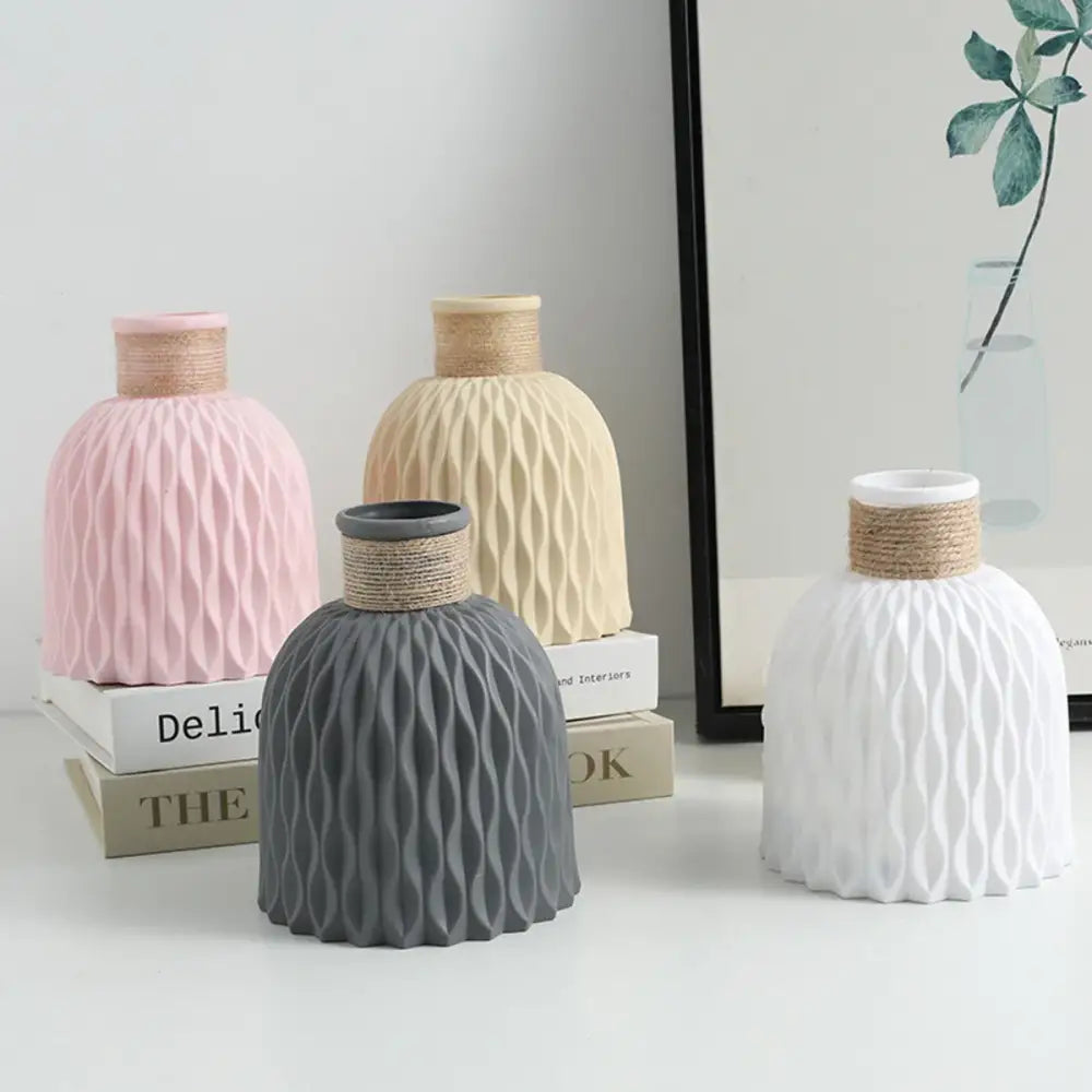 Set of four DecorBites™ water ripple plastic vases in pastel pink beige gray and white with textured wavy patterns and twine necks