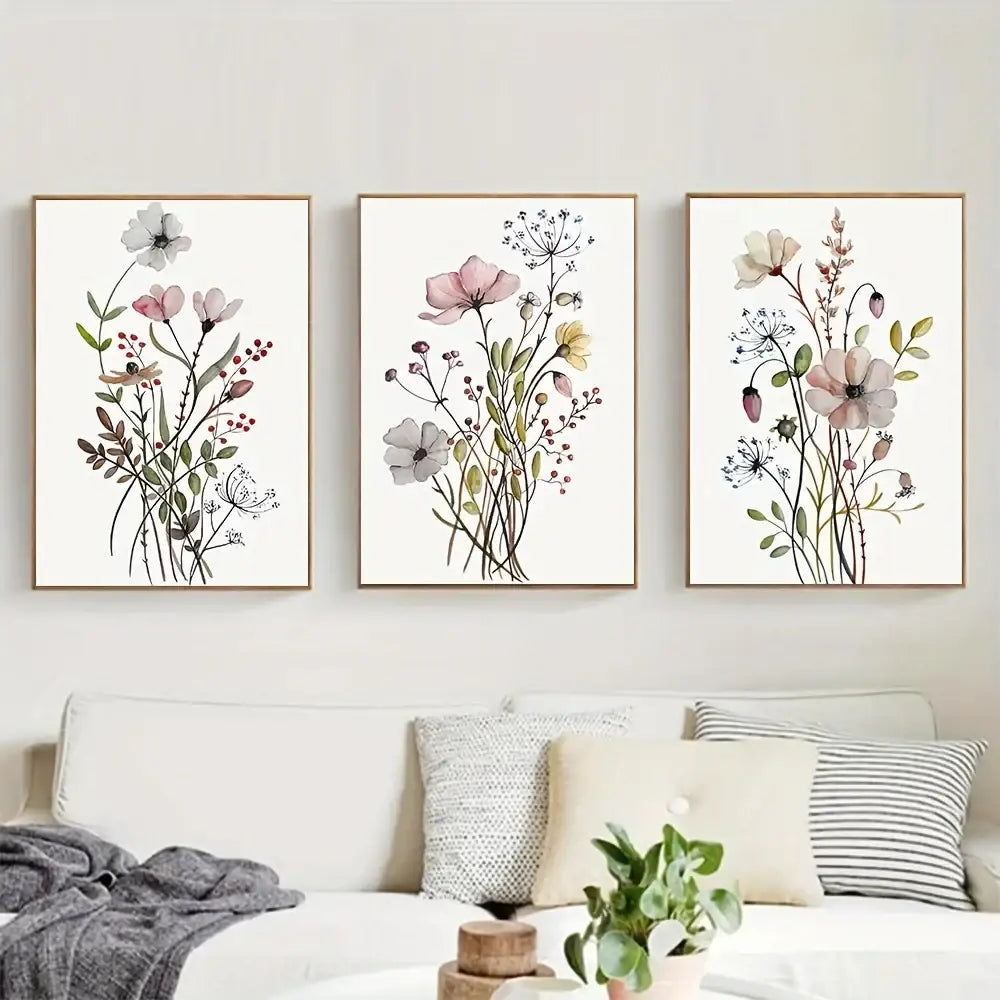 Three framed watercolor flower posters with delicate pink and white blooms on cream botanical canvas art by decorbites