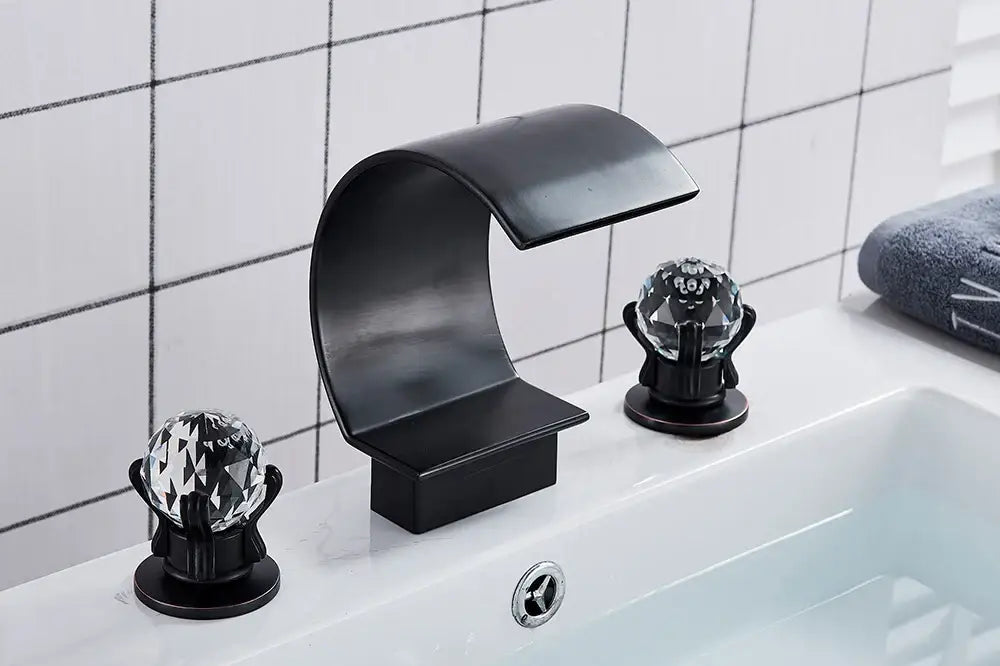 Black matte-finish DecorBites™ waterfall bathroom basin faucet with crystal globe handles for hot and cold mixer use