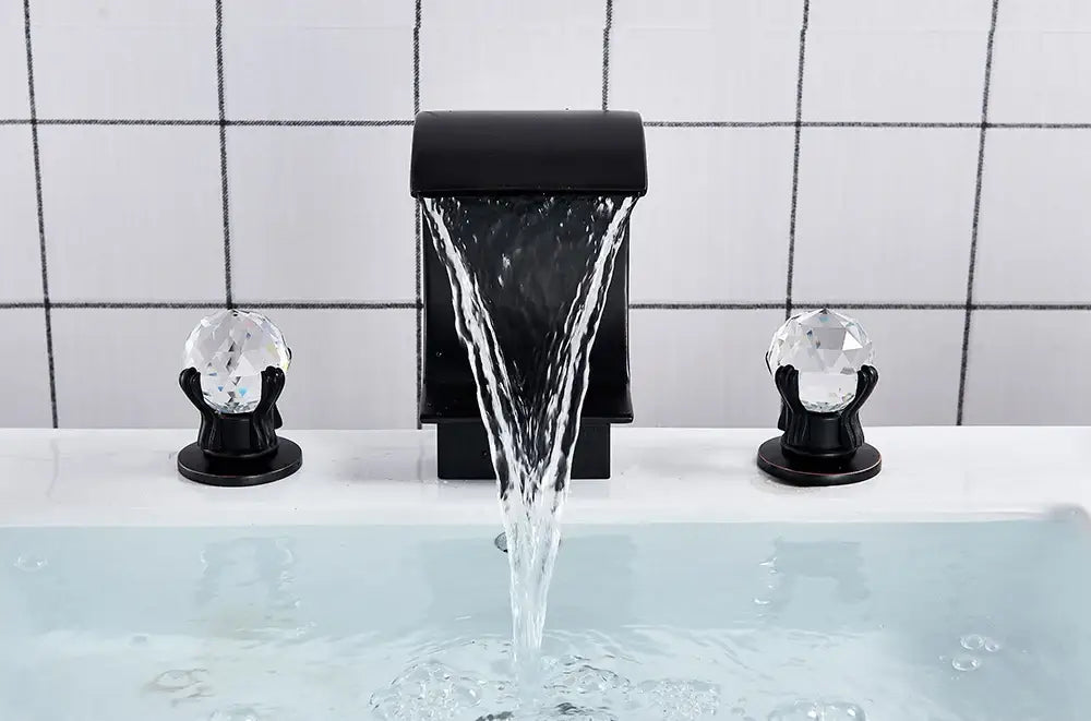 Black DecorBites™ waterfall bathroom basin faucet with crystal knob handles for hot and cold water mixing