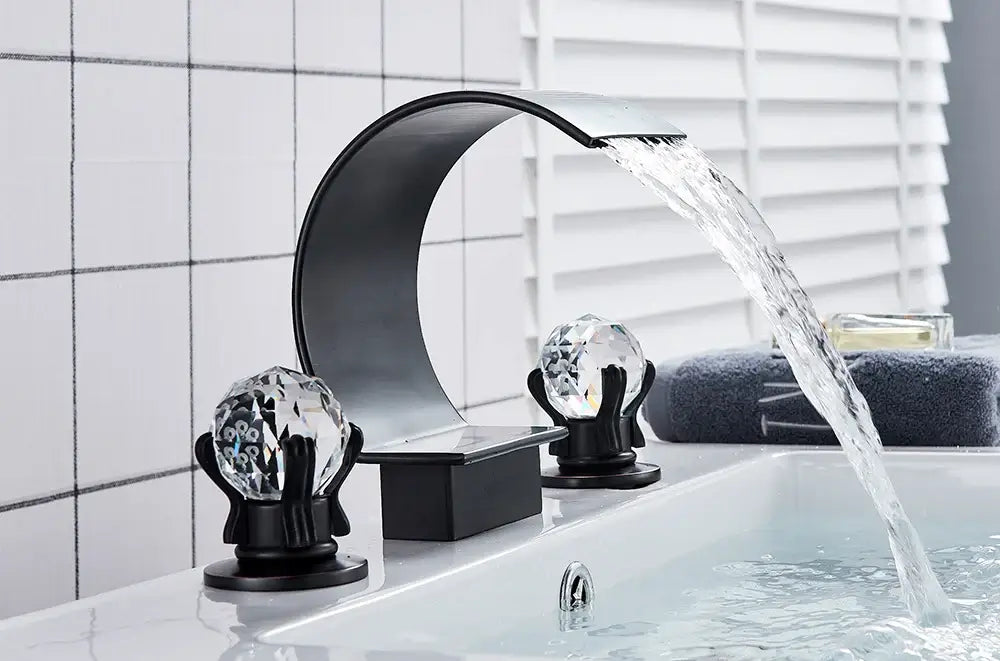 DecorBites™ waterfall bathroom basin faucet in black with crystal-like knobs and a curved waterfall spout for hot and cold mixing