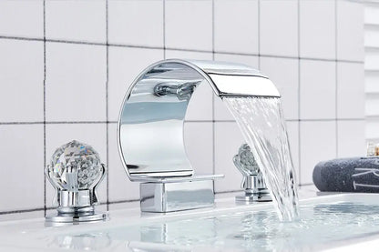 Chrome-finished DecorBites™ waterfall bathroom basin faucet with crystal encrusted handles and sleek curved spout