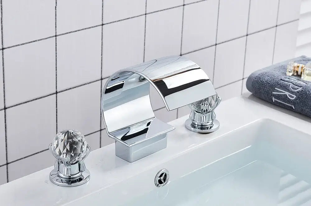 Chrome-finished DecorBites waterfall bathroom basin faucet with crystal knob handles for hot and cold water mixing