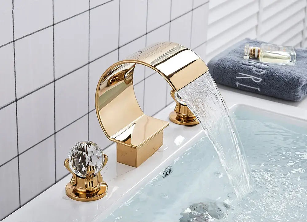 Gold waterfall bathroom basin faucet with crystal handles and sleek modern design from DecorBites hot cold mixer