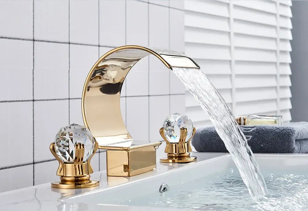 Decorbites™ gold-toned waterfall bathroom basin faucet with crystal knobs and sleek curved design for hot cold mixer