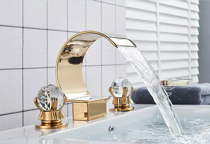 Decorbites™ gold-toned waterfall bathroom basin faucet with crystal knobs and sleek curved design for hot cold mixer