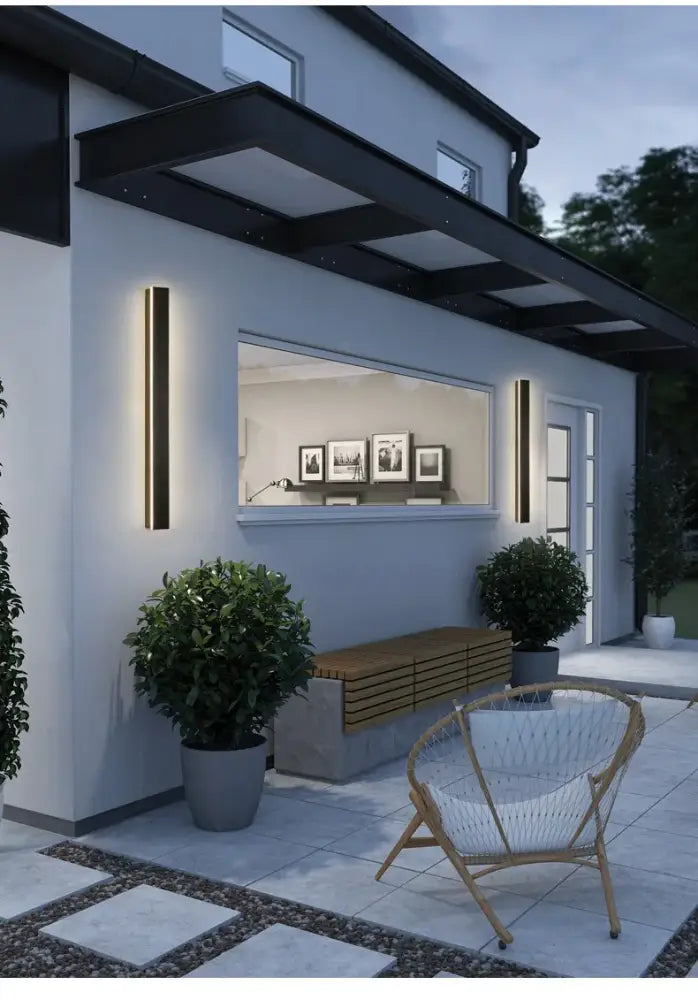 Modern black-framed vertical wall light with warm waterproof led lighting for outdoor use by decorbites