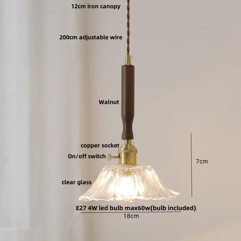 A delicate clear glass pendant light with a fluted design and dark walnut handle for vintage white ceramic led decor
