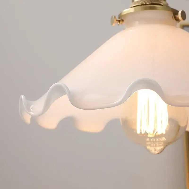 Vintage walnut and white glass led pendant light featuring a delicate white glass led pendant with scalloped edge brass hardware