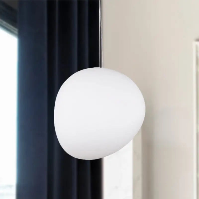 A sleek matte white glass oval pendant light from decorbites with minimalist design for ceiling hanging use