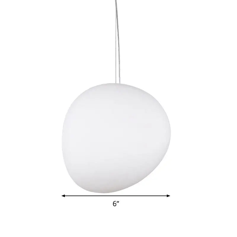 A sleek matte white glass oval pendant light with a smooth stone-like shape and thin metallic cord for ceiling mounting