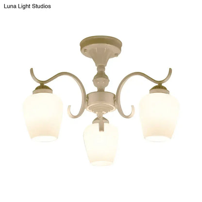 Cream-colored DecorBites™ chandelier with three curved arms and frosted opaline glass cone shades in countryside style