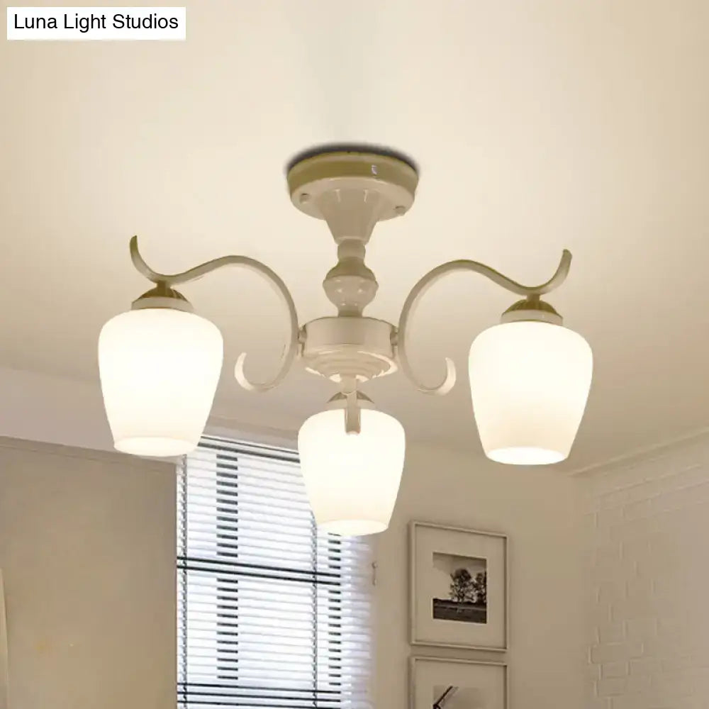 Cream-colored decorbites™ chandelier with three curved arms and frosted opaline glass cone shades for light bulbs