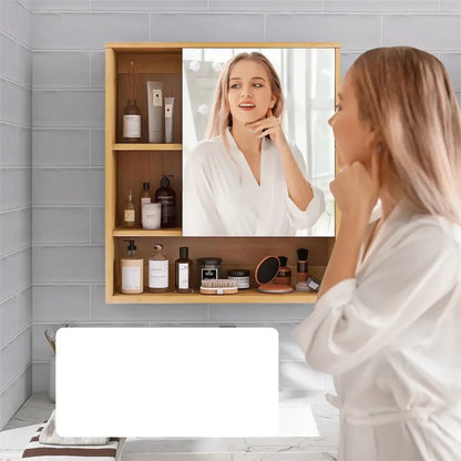 Decorbites™ wood medicine cabinet with light wood frame mirror and three shelves holding toiletries with woman reflection
