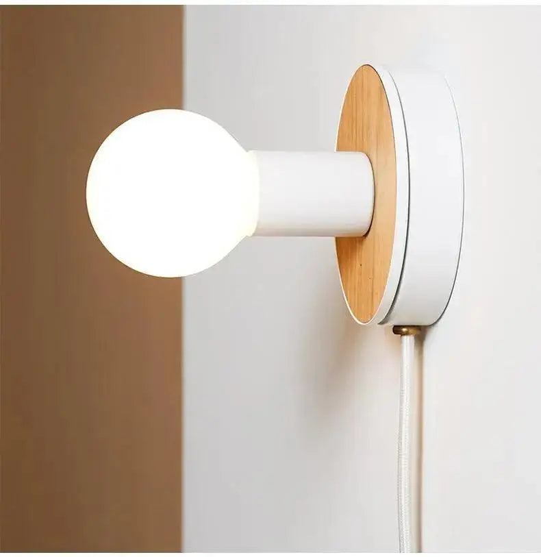 Minimalist decorbites™ wood plug-in wall sconce by bo-ha with white cylindrical stem, wooden backplate, and frosted glass bulb