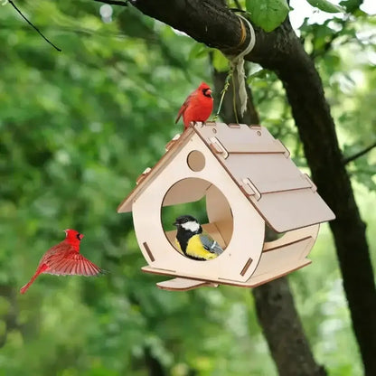 Light-colored wooden bird feeder with circular entrance and slanted roof hanging from tree branch for outdoor use