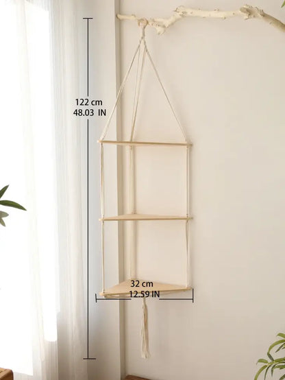 Beige macrame hanging wooden corner shelf with three tiers and tassel for boho wall decor by DecorBites