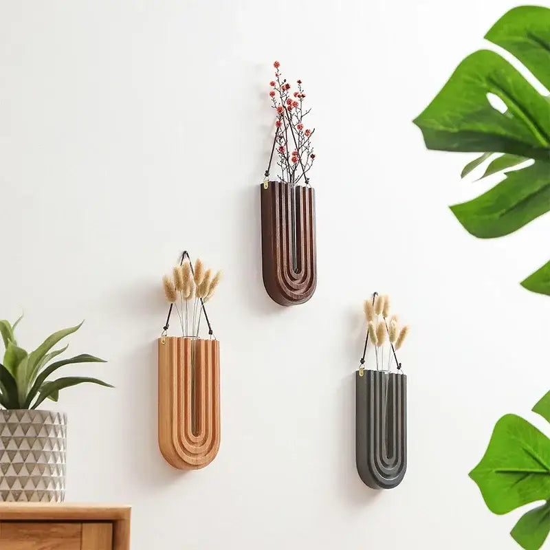 DecorBites wooden flower vase wall mount holder with three wood tone u-shaped planters holding dried flowers