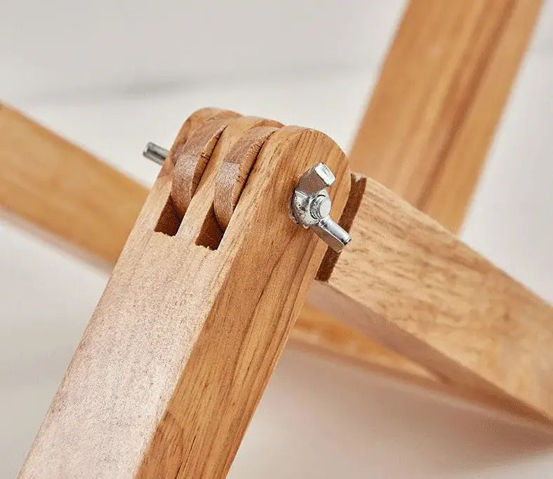 Light-colored wooden easel with silver wing nut securing joints for decorbites wooden robot shape creative table lamp