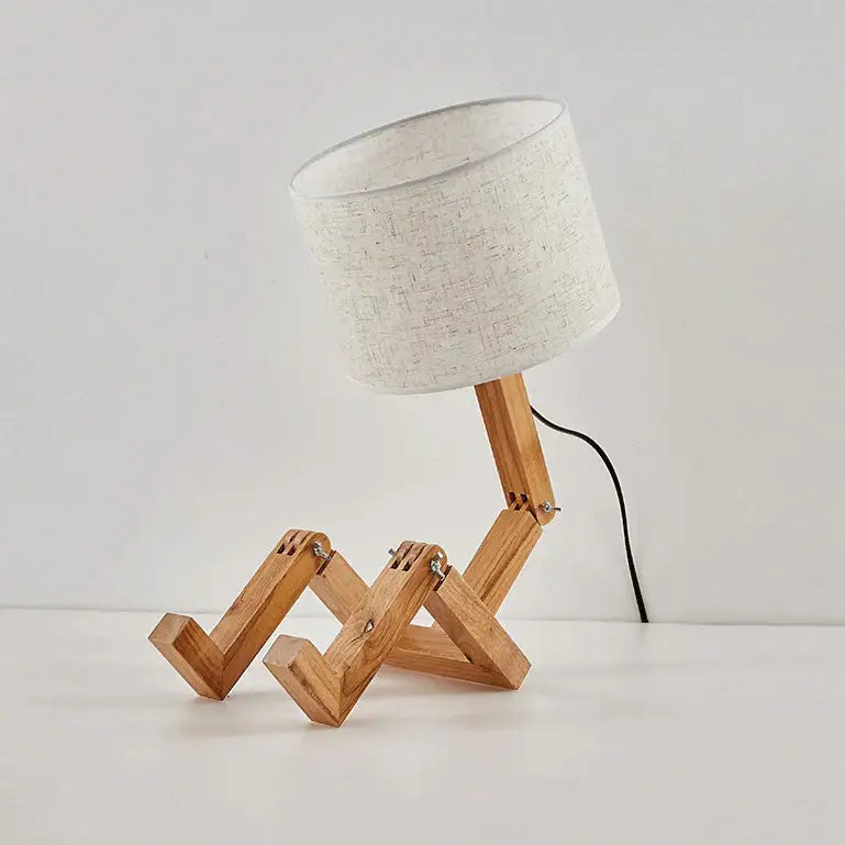 Minimalist wooden robot shape creative table lamp with beige fabric shade and articulated legs for indoor reading
