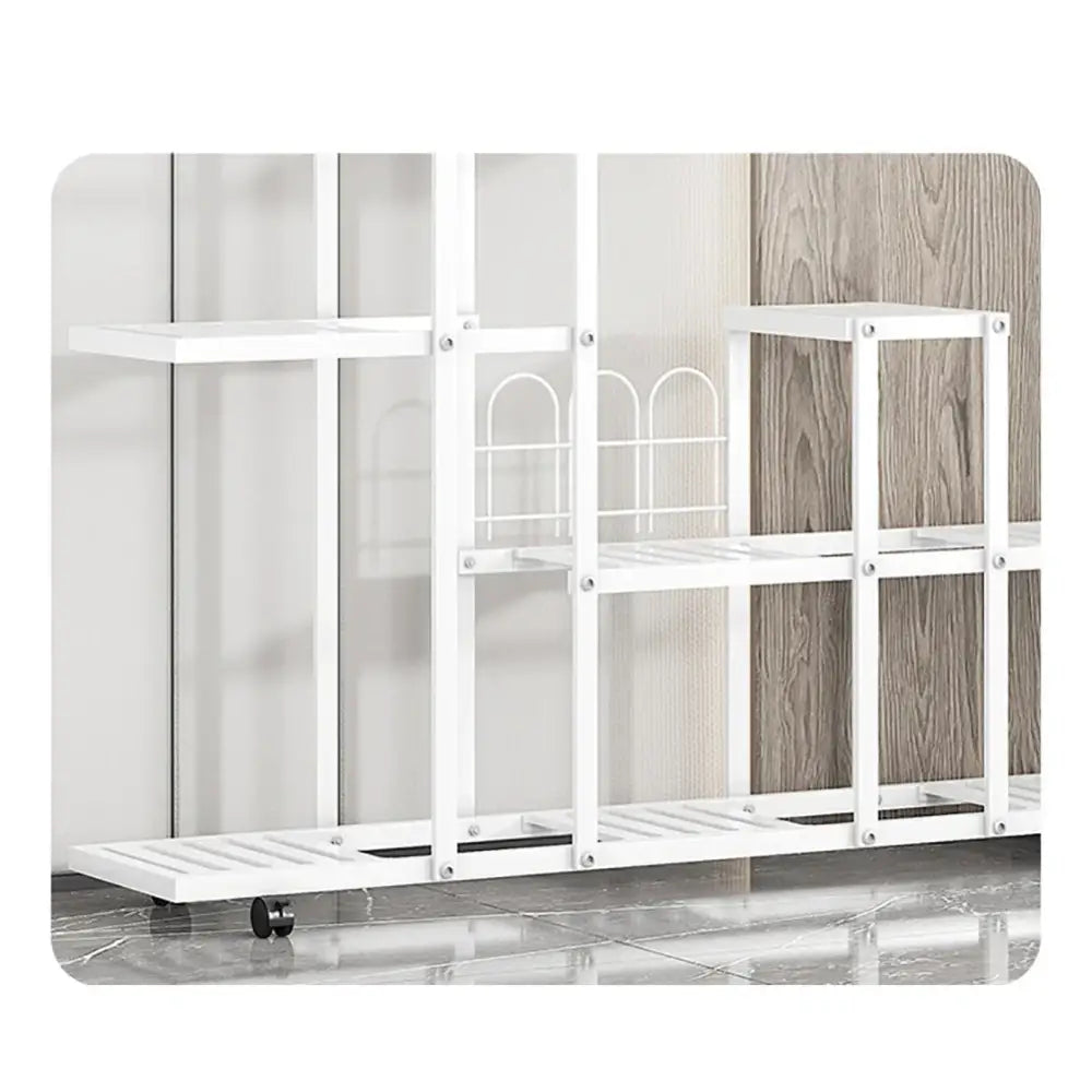 White wrought iron plant stand with multiple shelves decorative arched accents and wheels by decorbites