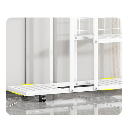 White metal rolling shelf with yellow accents and black wheels in a DecorBites wrought iron plant stand with wheels