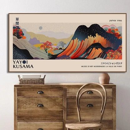 A framed vintage-style yayoi kusama flower art poster featuring a stylized mountain landscape in orange and blue hues