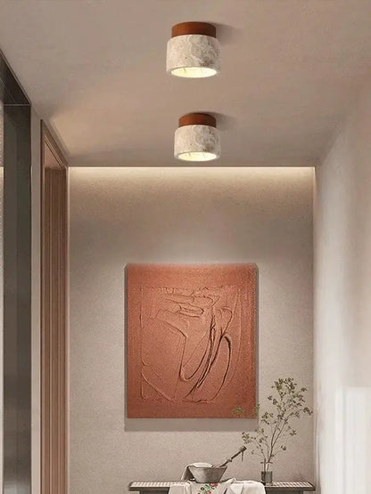 Two cylindrical decorbites™ yellow marble ceiling lights with textured white marble body and warm brown wooden top