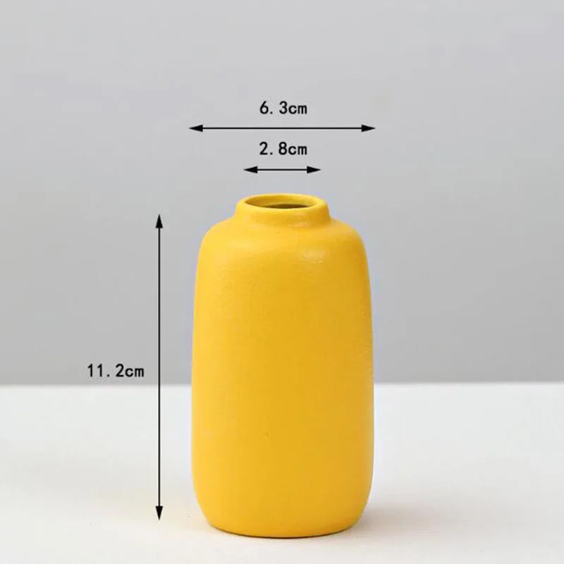 A sleek matte yellow porcelain flower vase with rounded body and narrow neck for elegant home decor by decorbites