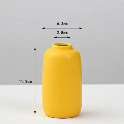 A sleek matte yellow porcelain flower vase with rounded body and narrow neck for elegant home decor by decorbites