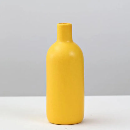 A sleek matte yellow porcelain flower vase by DecorBites for elegant home decor and floral arrangements