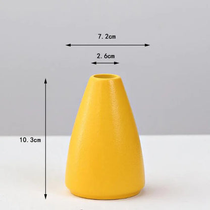A sleek matte yellow porcelain flower vase by DecorBites with a tapered conical shape for home decor