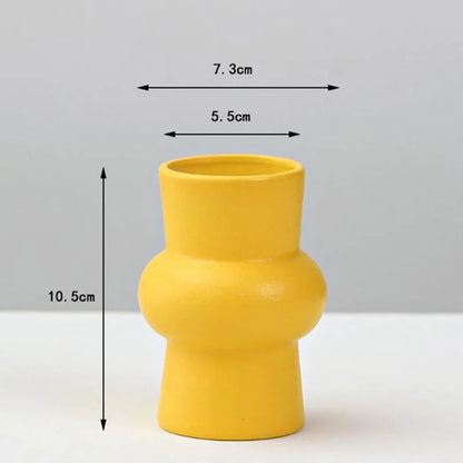 A vibrant yellow porcelain flower vase by DecorBites with a modern sculpted design for elegant home decor