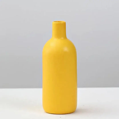 A sleek matte yellow porcelain flower vase by DecorBites for elegant home decor and floral arrangements