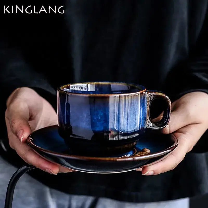Deep blue glossy ceramic espresso coffee cup with subtle vertical striations on matching coffee cup saucer set