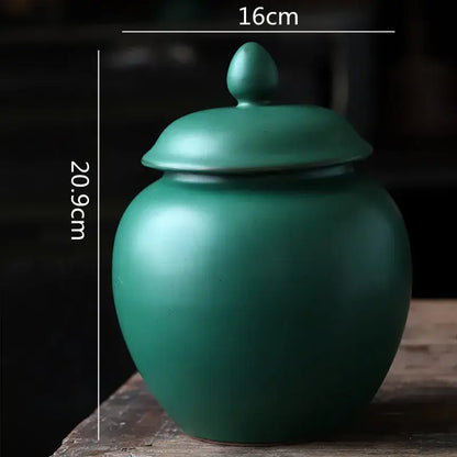 Deep green ceramic tea caddy jar with matte finish rounded body and lid for kitchen storage container