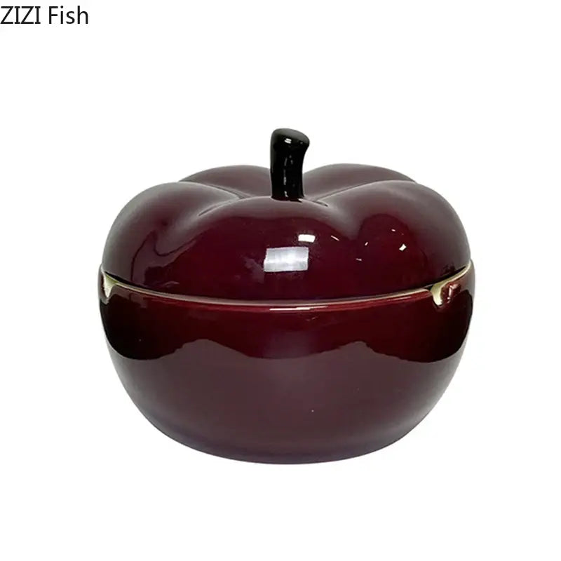 Glossy deep red ceramic apple ashtray with lid featuring black stem and gold-trimmed edges for living room decor
