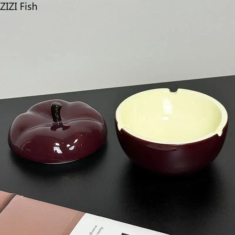 Deep red ceramic apple ashtray with lid featuring a glossy maroon exterior and pale yellow interior for decorbites decor