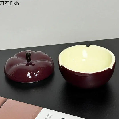 Deep red ceramic apple ashtray with lid featuring a glossy maroon exterior and pale yellow interior for decorbites decor
