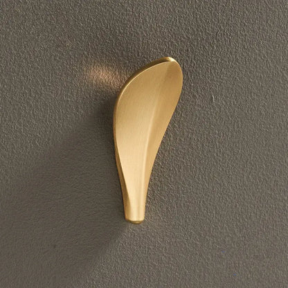 A sleek brushed gold brass wall mount robe hook shaped like a leaf for modern bathroom decorbites brass wall use
