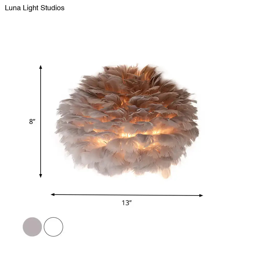 Designer wall sconce wall lamp featuring soft layered beige and brown feathers for bedroom decor
