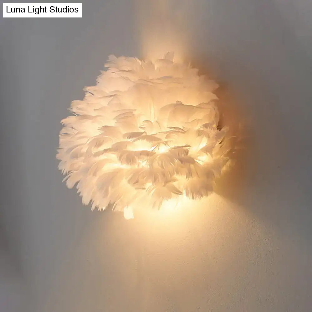 Designer feather white and grey wall sconce wall lamp featuring soft warm glow made from layered white feathers
