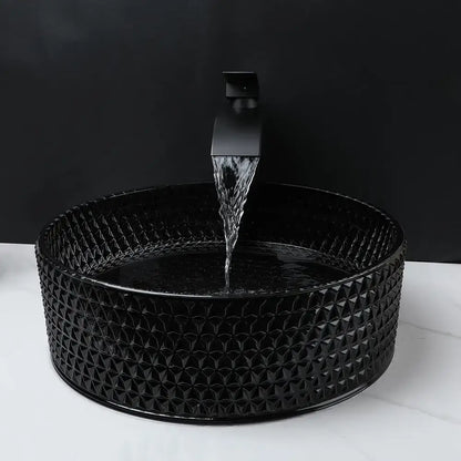 Black ceramic diamond glass basin set with textured pattern and matching matte black faucet for bathroom use