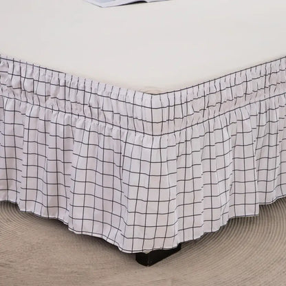 White bed skirt with black diamond lattice ruffled pattern and elastic band for a stylish bedroom decor